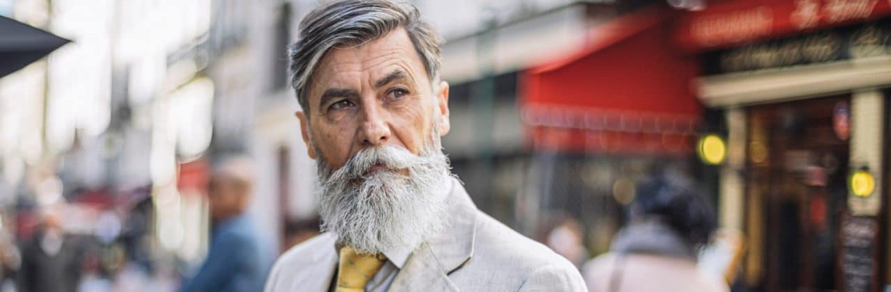Photo of a person cocking their head while looking down a city street