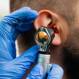 Man gets an ear exam.