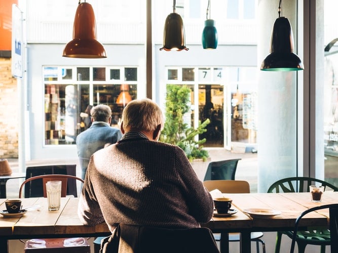 Man sitting alone in a coffee shop.
