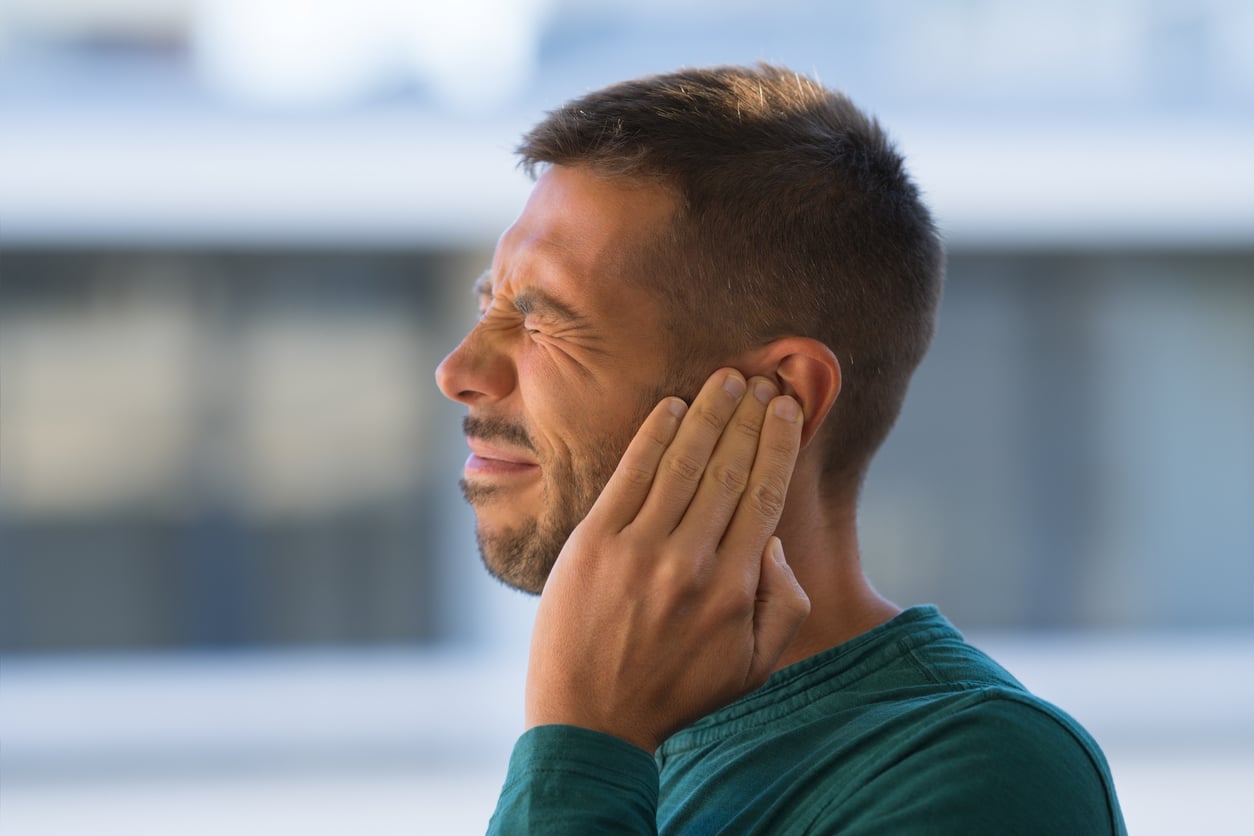 Man with tinnitus winces