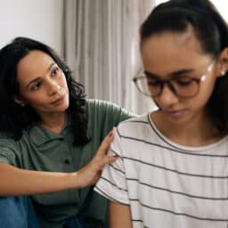 Mom and teenager daughter having an emotional talk