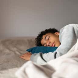 Teenager sleeping in his bedroom.
